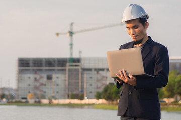 Worker using computer working outdoor on site construction ,Businessman holding laptop technology