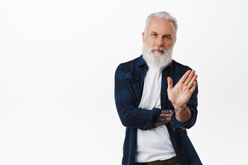 No thanks. Serious stylish old man shaking hand in refusal, rejecting offer, dislike something,...