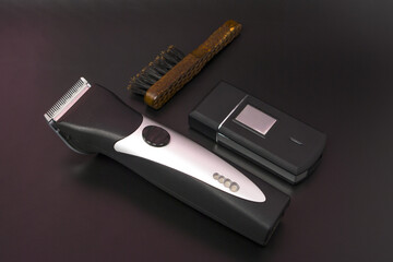 Professional Barbering Tools. Hair Clipper With Metal Blades, Brush And Shaver. Stylized In Classic Dark Background.