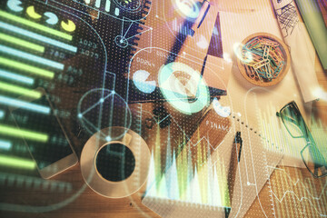 Double exposure of technology theme drawing over work table desktop. Top view. Global data analysis concept.