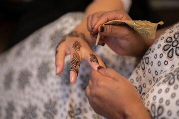 Traditional henna being applied on a girl