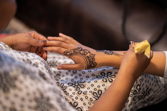 Traditional henna being applied on a girl