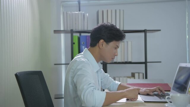 Business concept of 4k Resolution. Young Asian men are tired of working in the office.