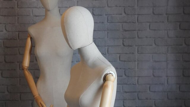 A modern fabric mannequin spins against the wall. Shop concept, sale