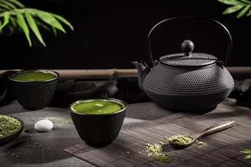 Foto op Aluminium Matcha tea powder and tea accessories on dark background. Tea ceremony. Traditional japanese drink. © Miguel Tamayo 