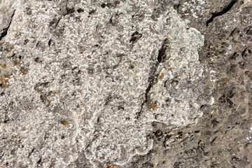 Natural mountain stone in a natural environment, rough surface burnt out in the sun and exposed to natural destruction.