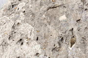 Natural mountain stone in a natural environment, rough surface burnt out in the sun and exposed to natural destruction.