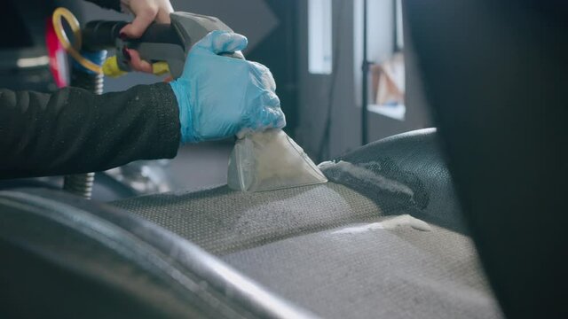 Professional car cleaning. ar wash. Dry cleaning and detailing of the cabin. Cleaning the car panel from dust.