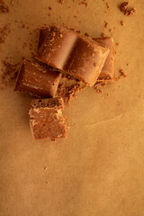 chocolate bars, chocolate chips on a brown background