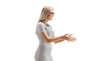Young blond woman waiting to receive something and gesturing with hands