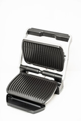 electric grill with open lid. appliance for cooking in everyday life. Made of stainless steel, special non-stick coating. healthy food. food without oil and fat. 