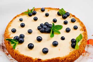 homemade cheesecake decorated with blueberry berries and mint leaves. Cooking desserts and cakes. Confectionery.