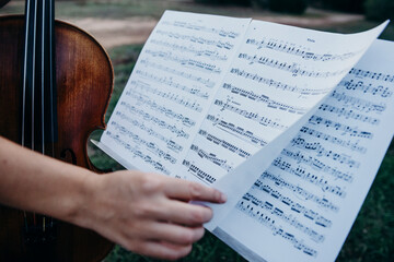 photos of a violin and sheet music