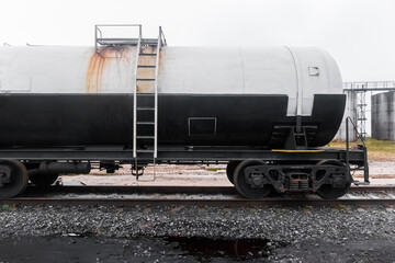 Fototapeta na wymiar Dirty railway tank car with fertilizers or chemical products after unloading at an industrial plant