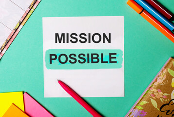 MISSION POSSIBLE written on a turquoise background near bright stickers, notepads and markers