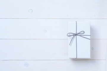 An empty cardboard box with a leather bow that is used for keeping gifts brought together on a...
