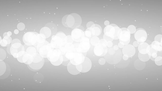 Abstract animation of defocused white particles on gray background