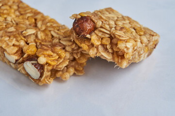 Two pieces of granola bar on white table