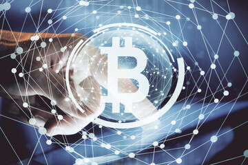 Double exposure of man's hands holding and using a phone and crypto currency blockchain theme...