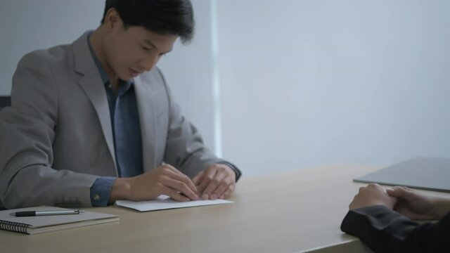 Business concept of 4k Resolution. Young Asian men are accepting job offers in the office.