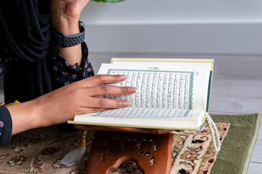 Black Muslim Woman studying quran
