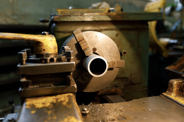 A lathe with a blank in the spindle. Old equipment at the factory from the mid-20th century.