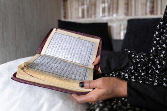 Black Muslim Woman studying and reading quran