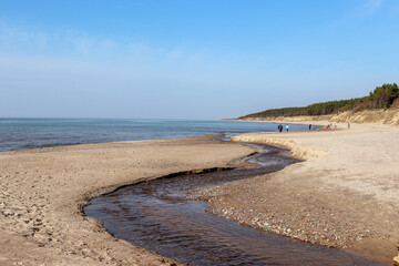 River on the beach witvh flows into the sea