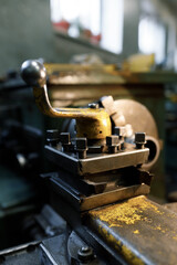 Old locksmith lathe, components and tools. Lathe close-up, metal with a blurred background.