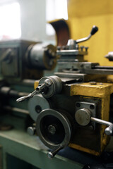 Fototapeta na wymiar Old locksmith lathe, components and tools. Lathe close-up, metal with a blurred background.