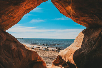 View on the beach through the cave