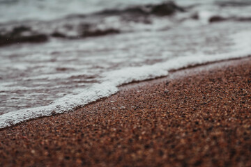 Fototapeta na wymiar Close up on sand and waves