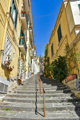 Fototapeta na wymiar A narrow street between old buildings in the city of Naples in Italy.