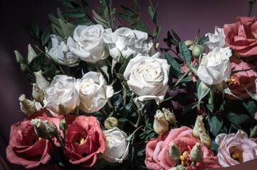 Background for a greeting card - a bouquet of fresh roses in a festive package