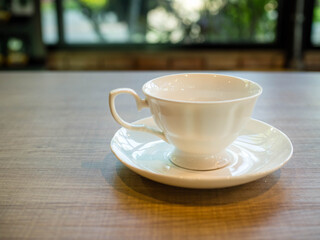 coffee cup on a wooden table in a coffee shop.