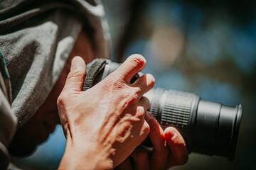 hands of a photographer with a camera close-up without a face