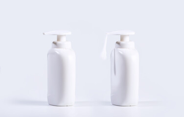 Two Plastic Bottles with liquid soap, one pouring soap