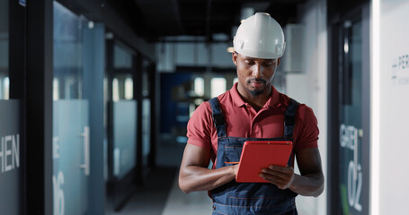 Diverse couple of adult and young electricians coworking in corporate office center repairing...