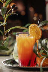 Aperol Spritz orange cocktail with slices of orange on silver tray