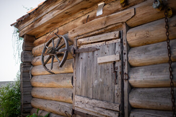 Old wooden cart wheel on the wall