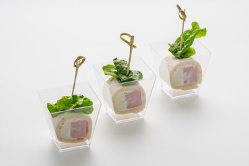 canapes with ham and cheese on a white background. Catering. Delivery. A party