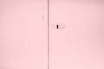 old lock on pink wooden door