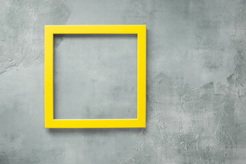 Yellow empty  frame on  rustic gray  surface. Top view, blank space