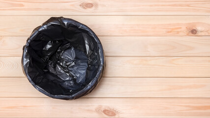 Trash Can Top View. Empty Garbage Bin Banner. Black Bag in a Trash Can. Rubbish Bin. Empty Bin on Wooden Floor. Waste Bin on Wooden Background. Waste Can with Plastic Package. Banner Garbage Basket