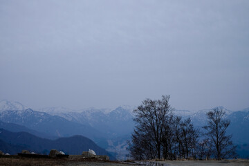 Beautiful Mountain range of Japanese alps view in early morning as misty viewed from parking area in Hokkaido, Japan.