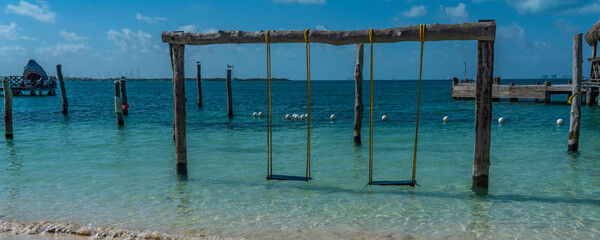 Swing over turquoise water at Isla Mujeres, Cancun