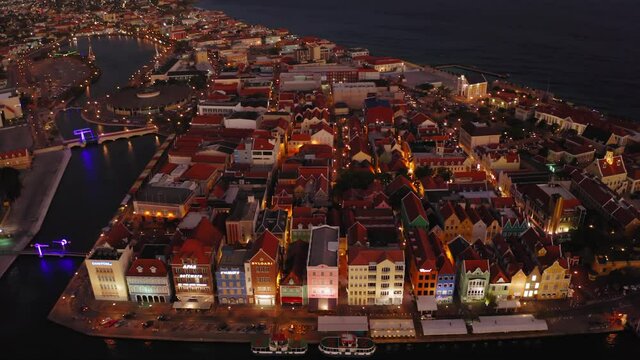 aerial drone image of the city of curacao in the caribbean at night