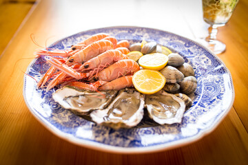 Seafood (langoustines, oysters and clams) on plate
