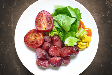 Sliced grilled sausages (Asian style) on white dish