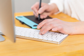 A graphic designer works on a digital tablet. work from home